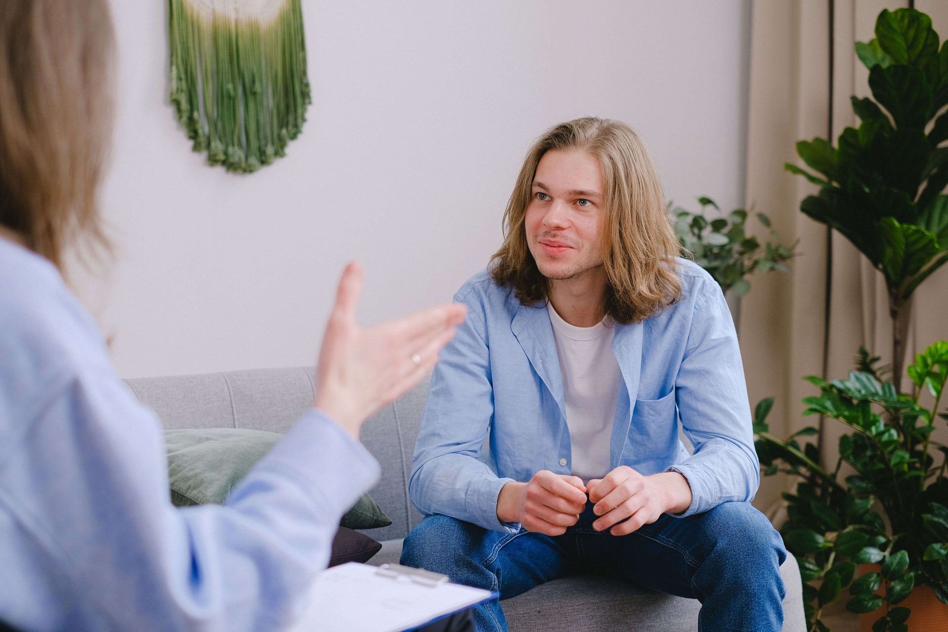Person smiling during a therapy session, representing increased confidence, nervous system regulation, and healing through anxiety therapy in Omaha, NE | anxiety therapy omaha ne - anxiety counseling omaha ne - anxiety therapist omaha ne - elkhorn - gretna - bennington - blair - millard - wahoo - waverly - papillion