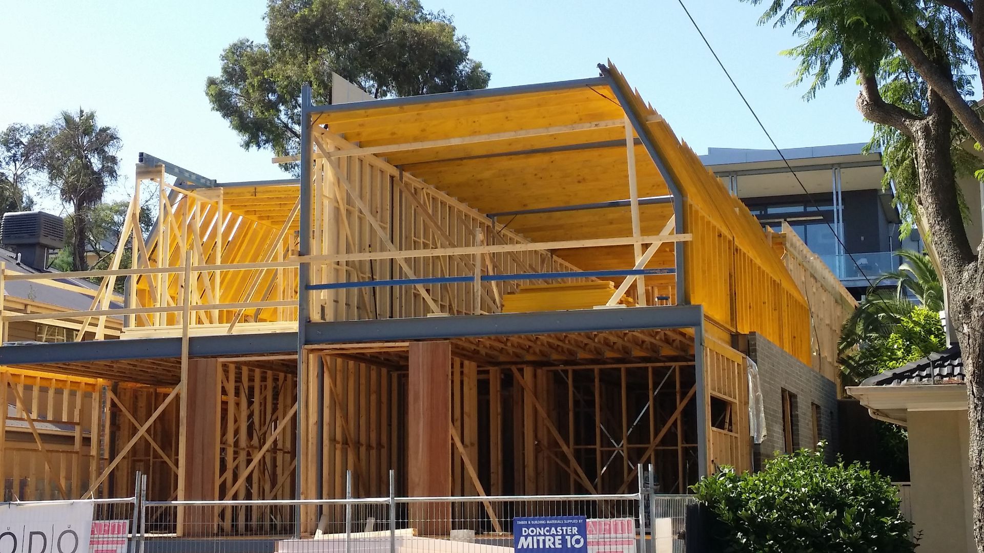 A house is being built on a sunny day.
