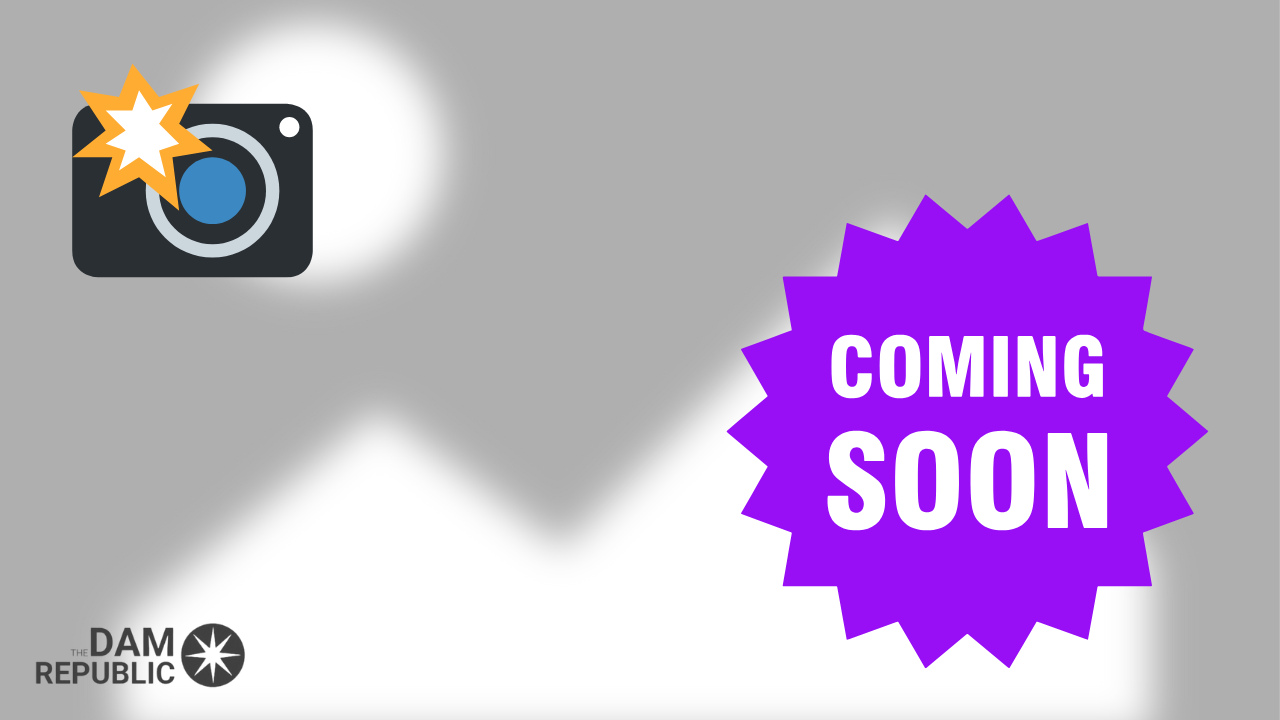 A sign that says coming soon next to a camera