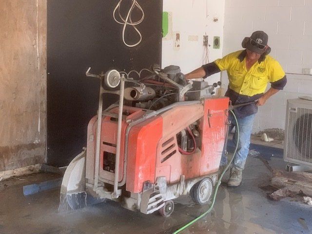Worker Using Machine Cutting Concrete — Concrete Cutting In West Mackay, QLD