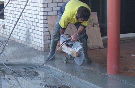 Tradie Cutting Concrete Floor — Concrete Cutting In West Mackay, QLD
