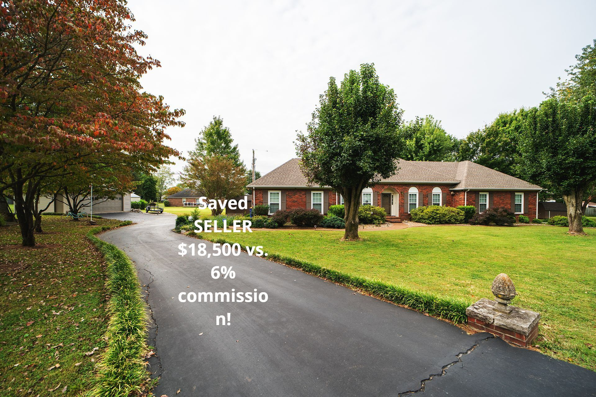 Driveway leading to a brick house, with text
