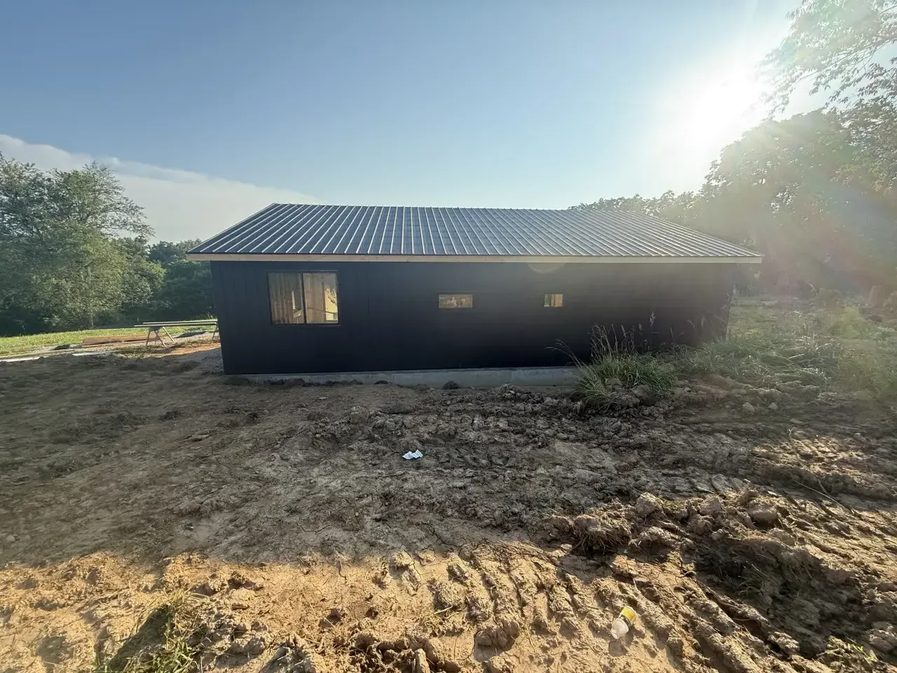 A kitchen with a stove , refrigerator , microwave and sink.