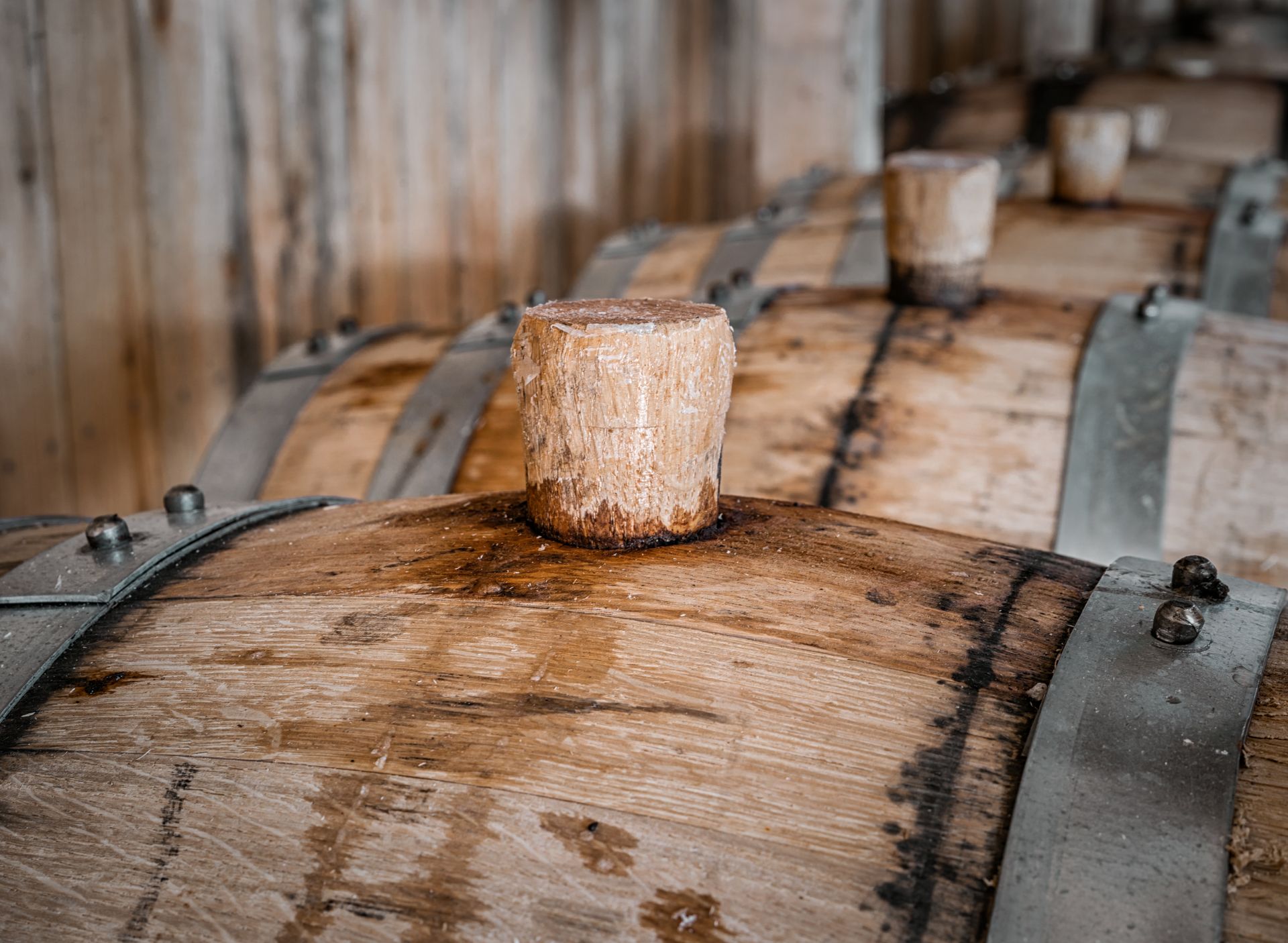A close up of a wooden barrel with a cork on top.