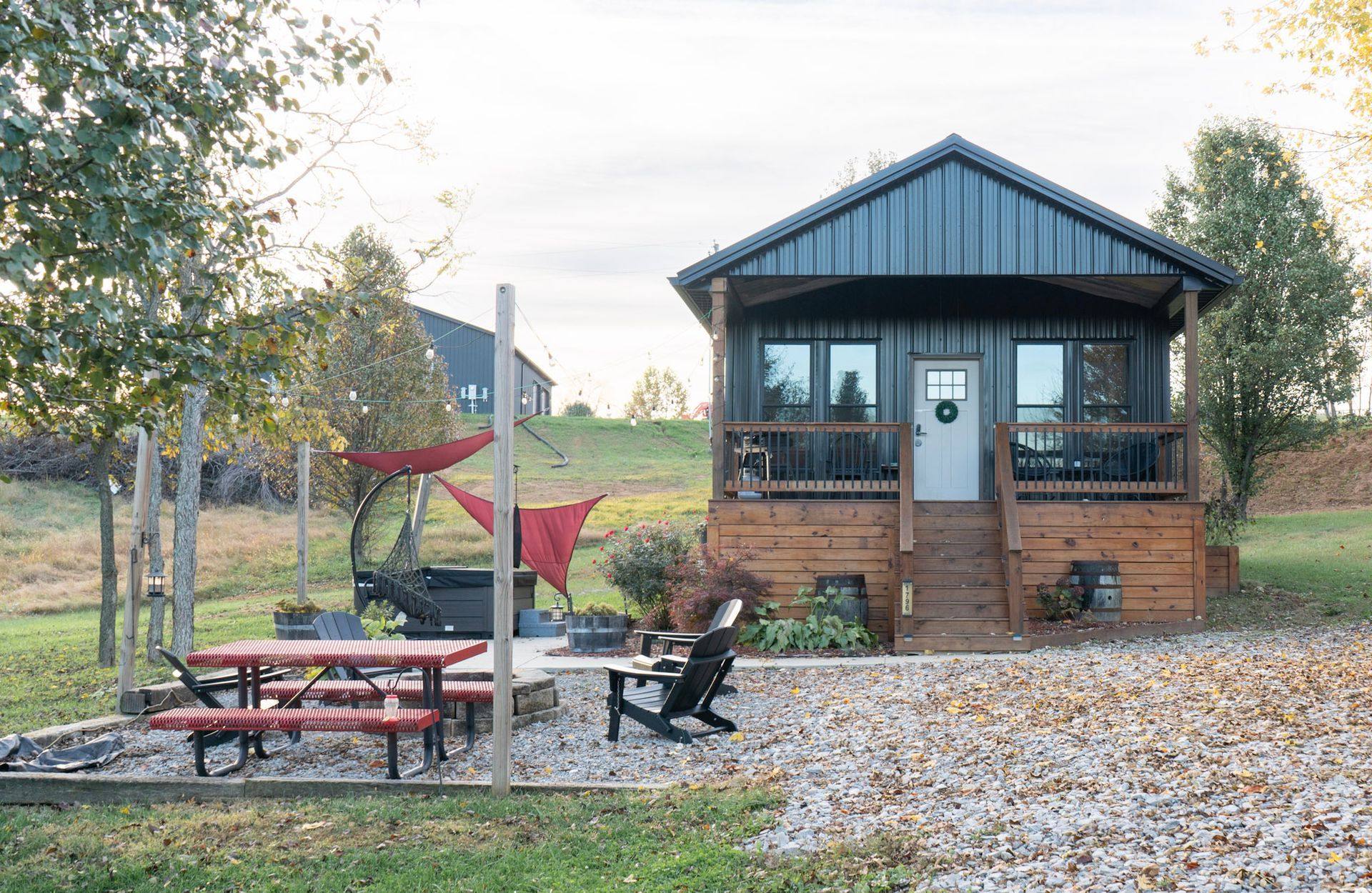 A living room in a log cabin with a couch , coffee table and chairs.