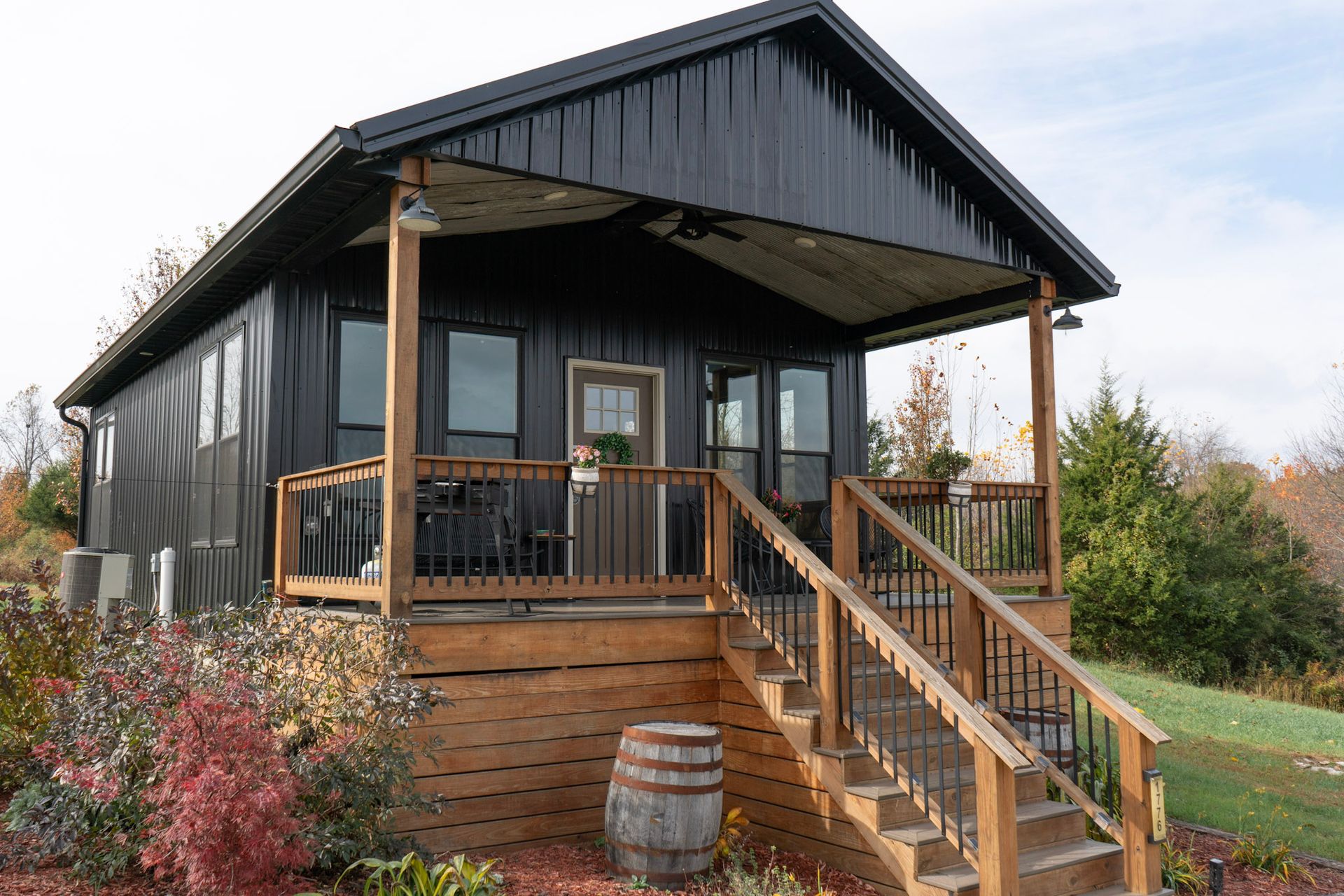 A kitchen with a stove , refrigerator , microwave and sink.