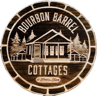 A wooden sign that says bourbon barrel cottages on it