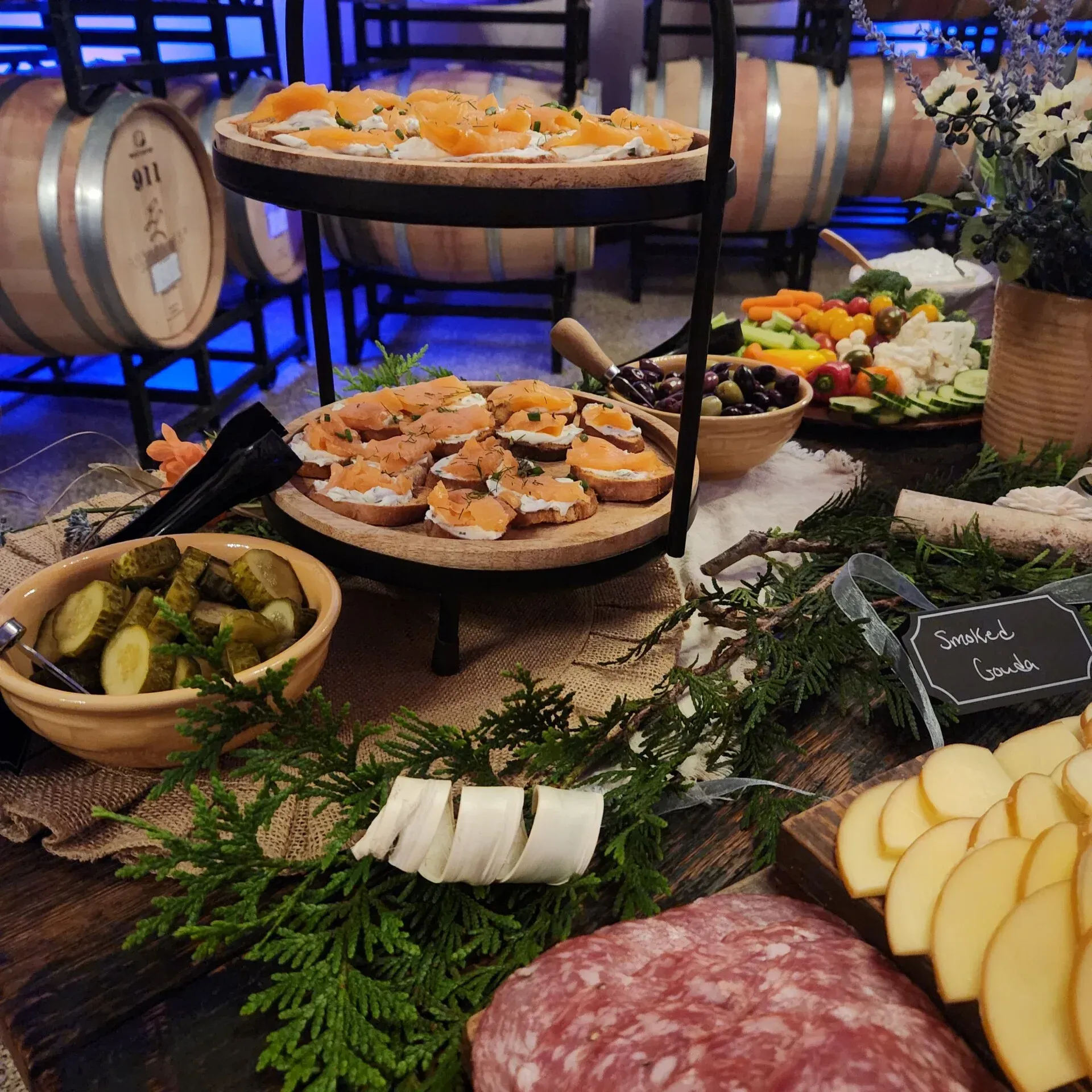 A man with a tattoo on his arm is cutting green onions on a cutting board.