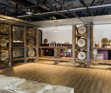 A room filled with wooden barrels and a table.