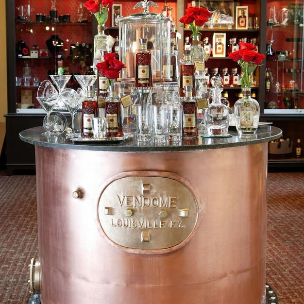 A copper table with a plaque that says vendeme on it