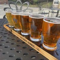 A tray of beer glasses sitting on top of a table.