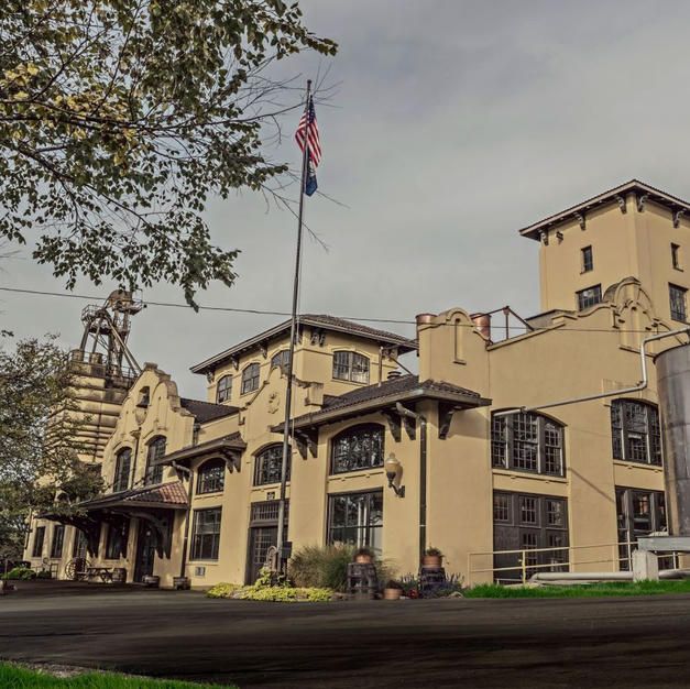 A large building with a flag flying in front of it