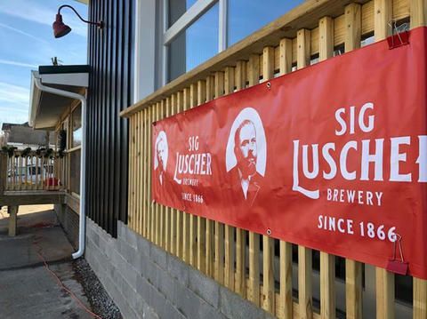 A sign on the side of a building that says sig luscher brewery since 1866