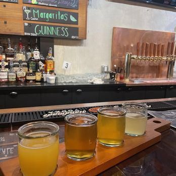 A bar with a sign that says margaritas and guinness