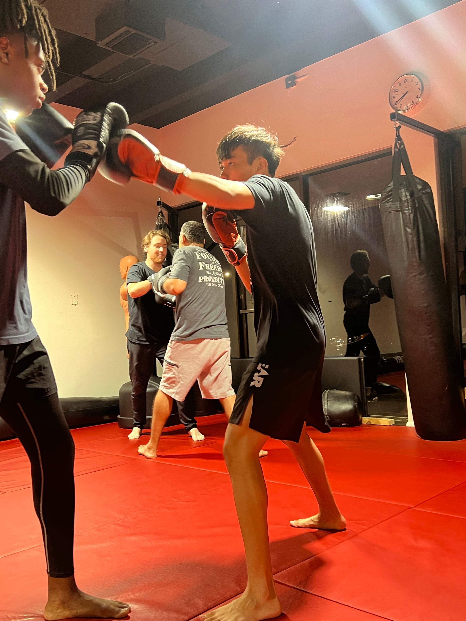 A group of young men are boxing in a gym.