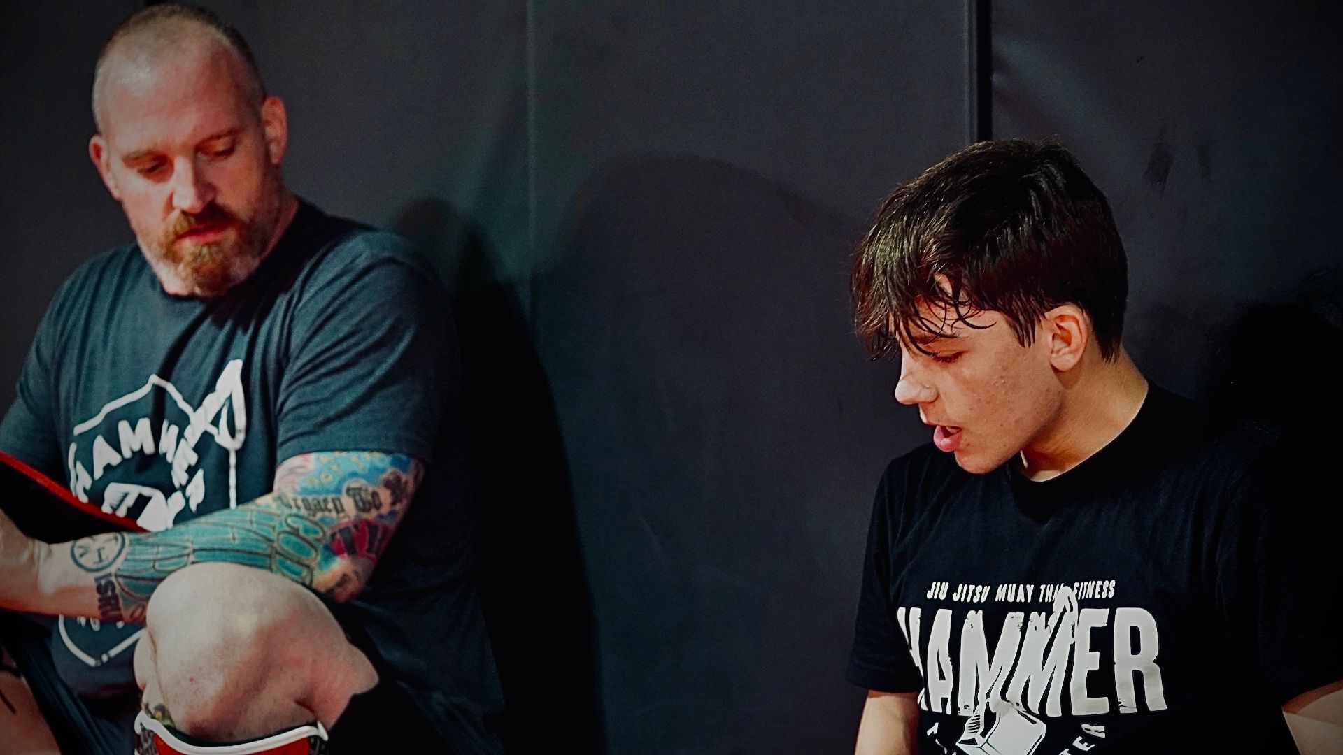 A group of people are practicing martial arts in a gym