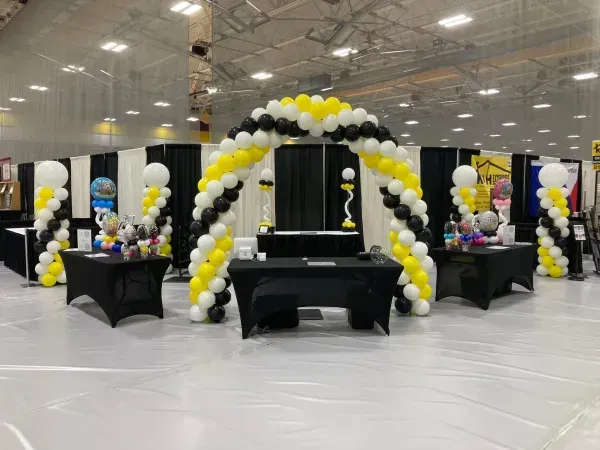 A large room filled with balloons and tables.