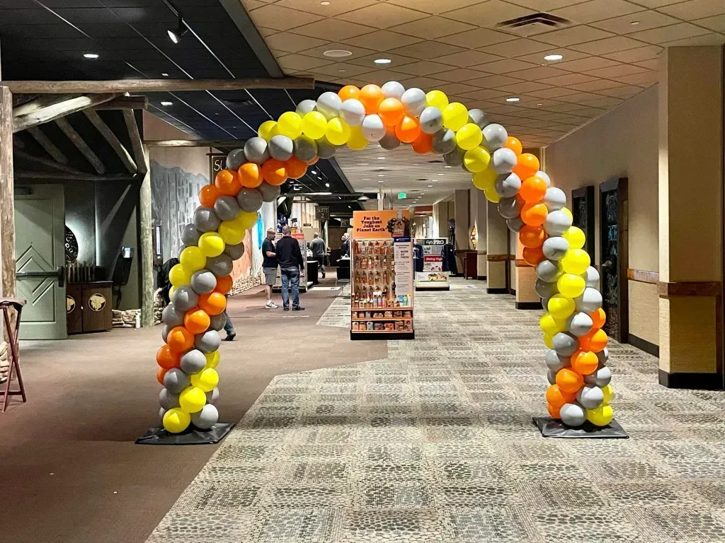 A hallway with a balloon arch in the middle of it.