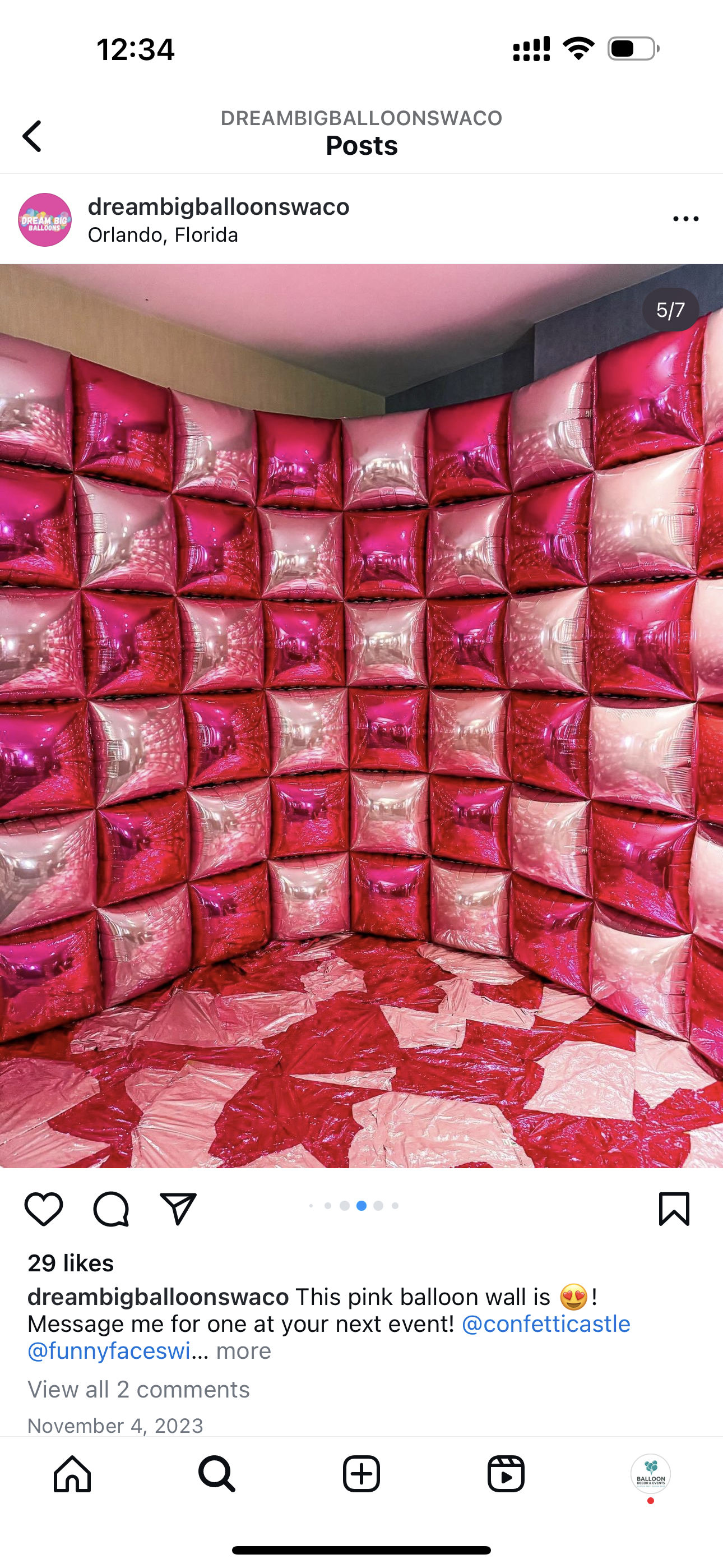 A room filled with pink and white pillows and balloons.