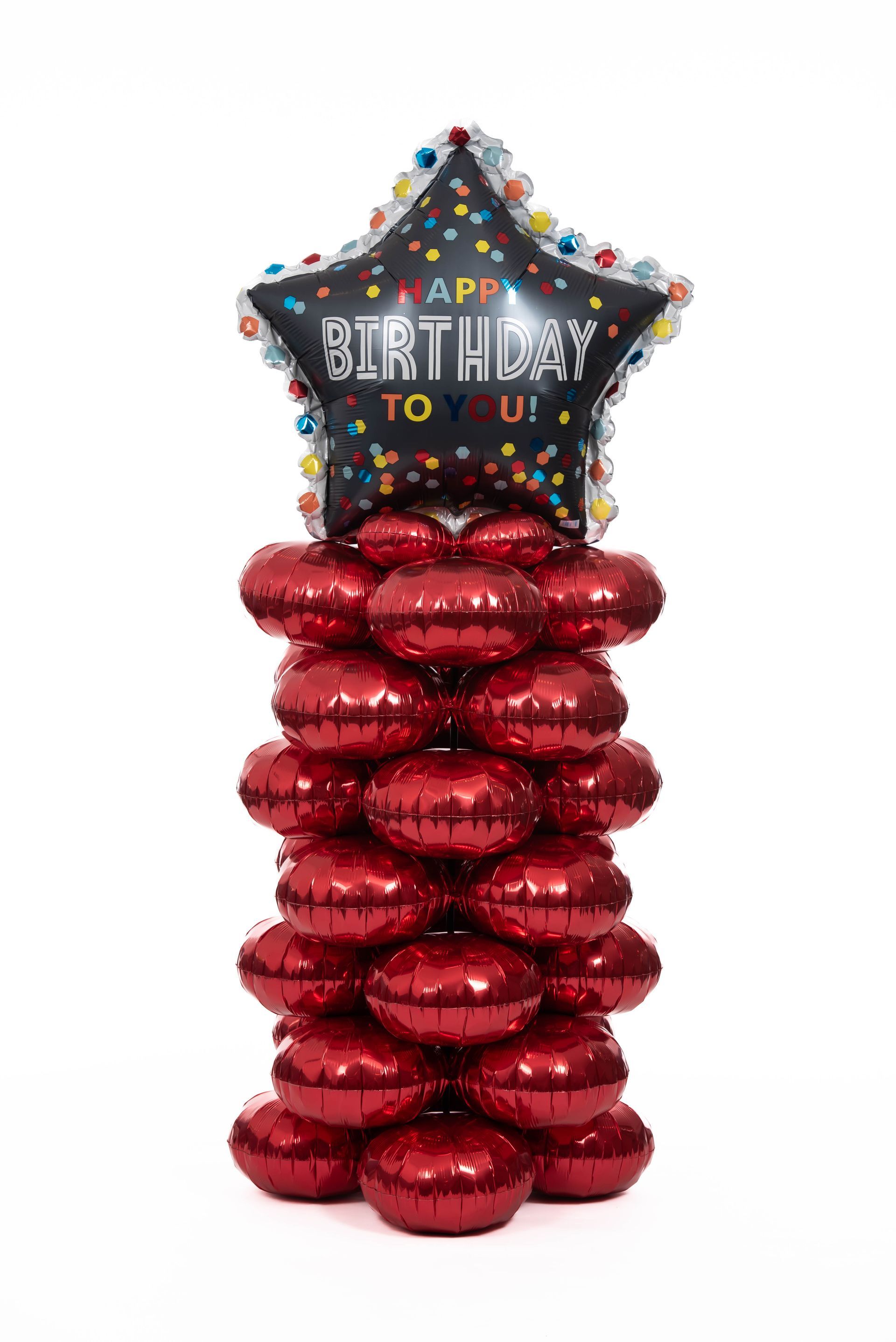 A stack of red balloons with a birthday balloon in the middle.