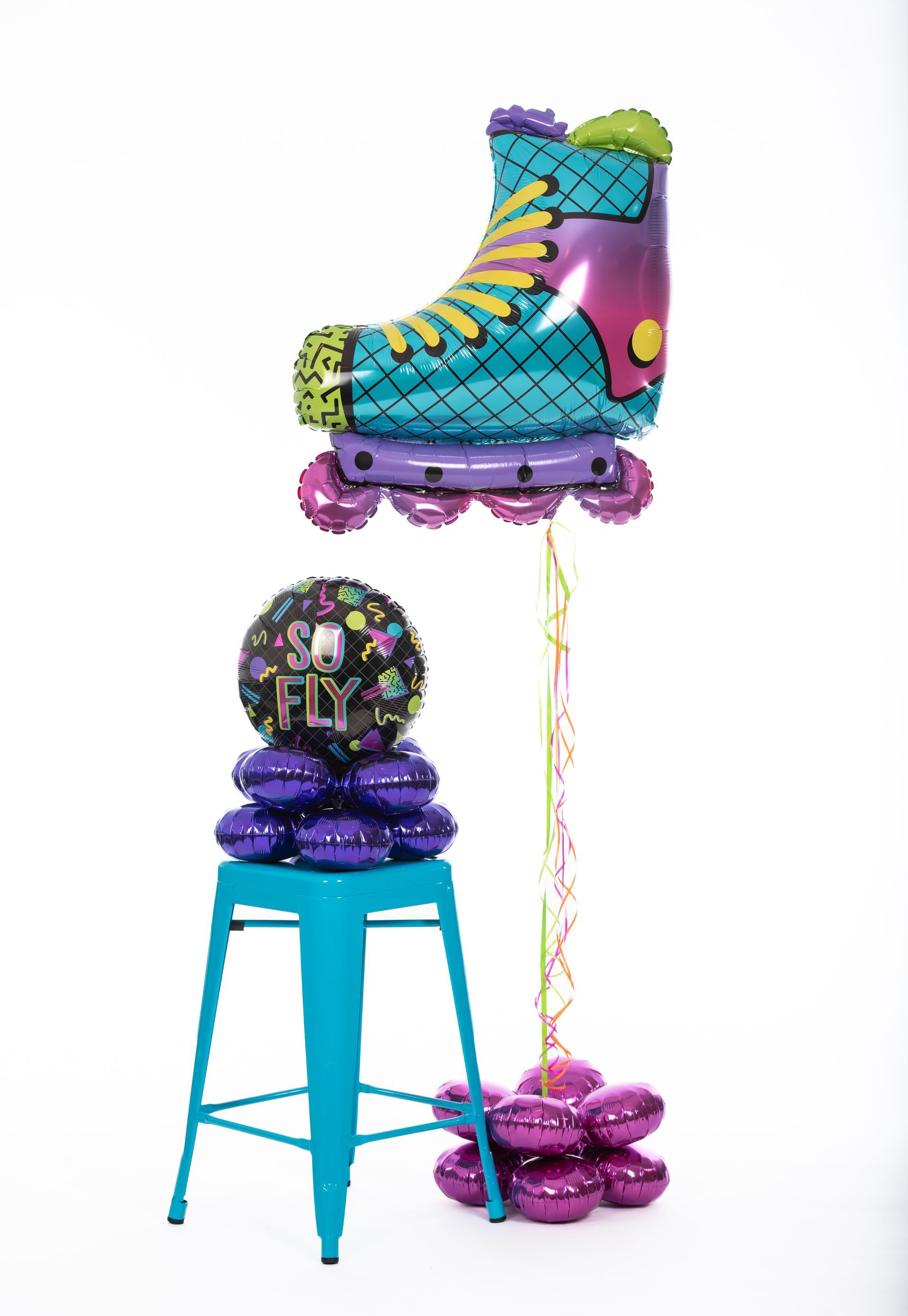 A roller skate shaped balloon is sitting on a blue stool