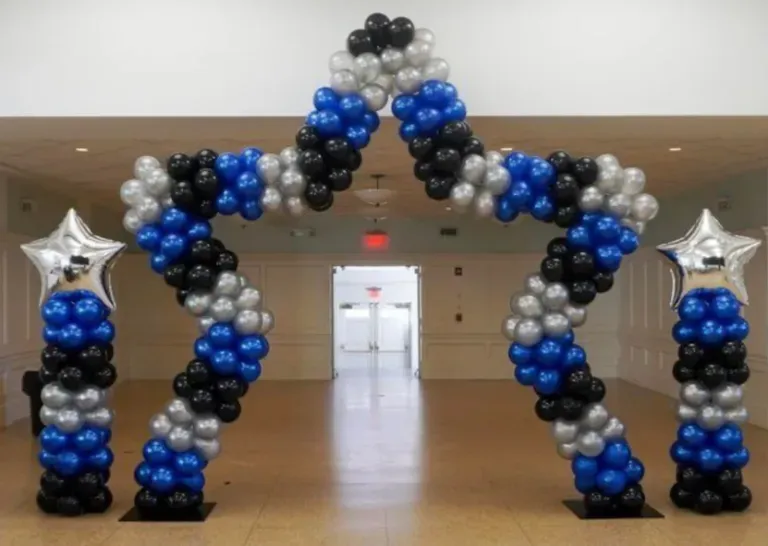 A large arch made of blue , black and silver balloons