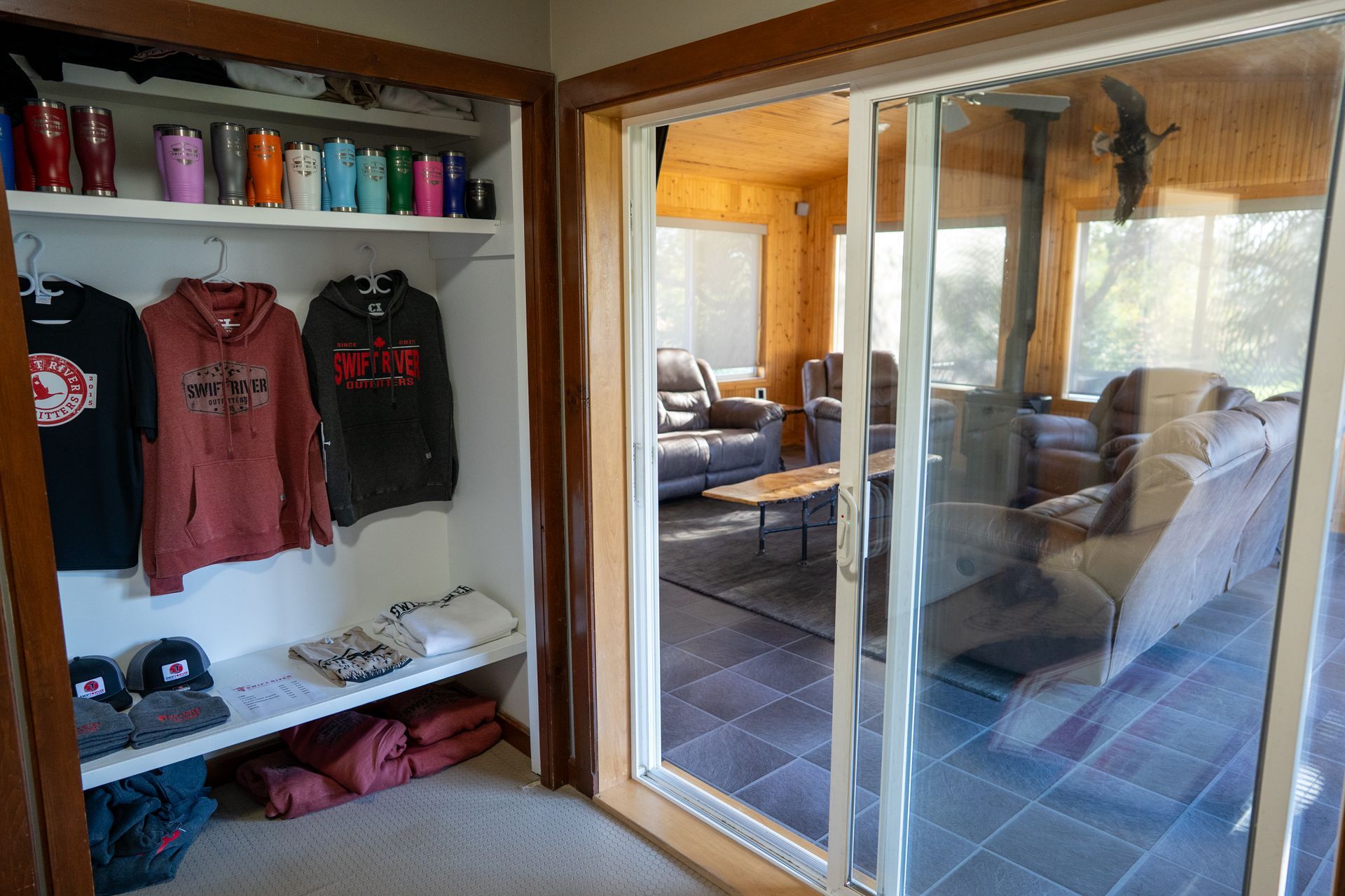 A room with a sliding glass door leading to a living room.