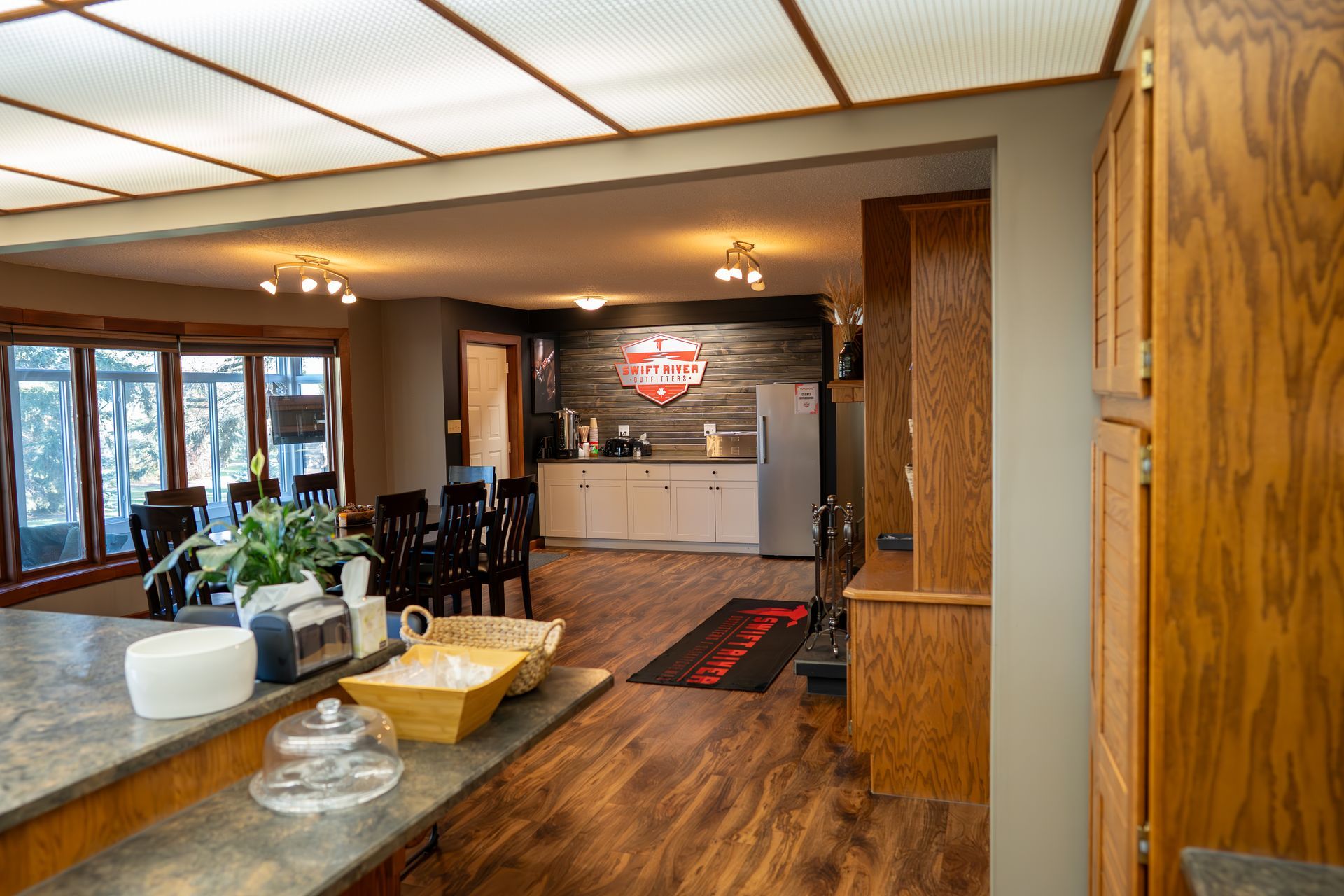 A kitchen and dining room in a house with a harley davidson sign on the wall.