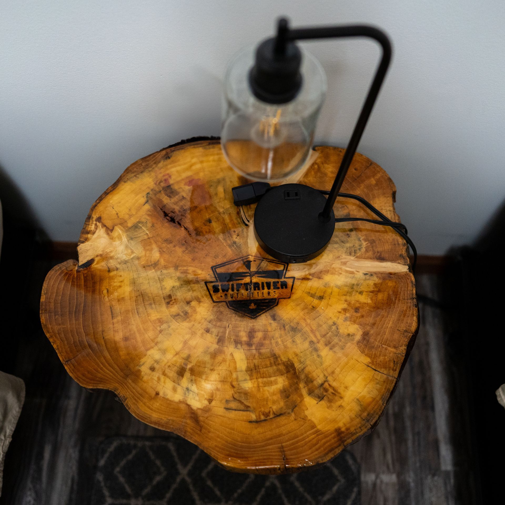 A wooden table with a lamp on top of it