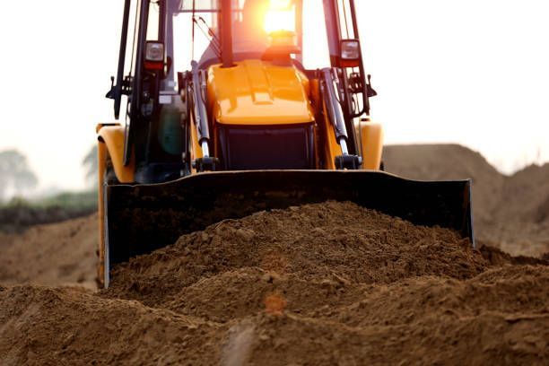A bulldozer is moving dirt on a construction site.