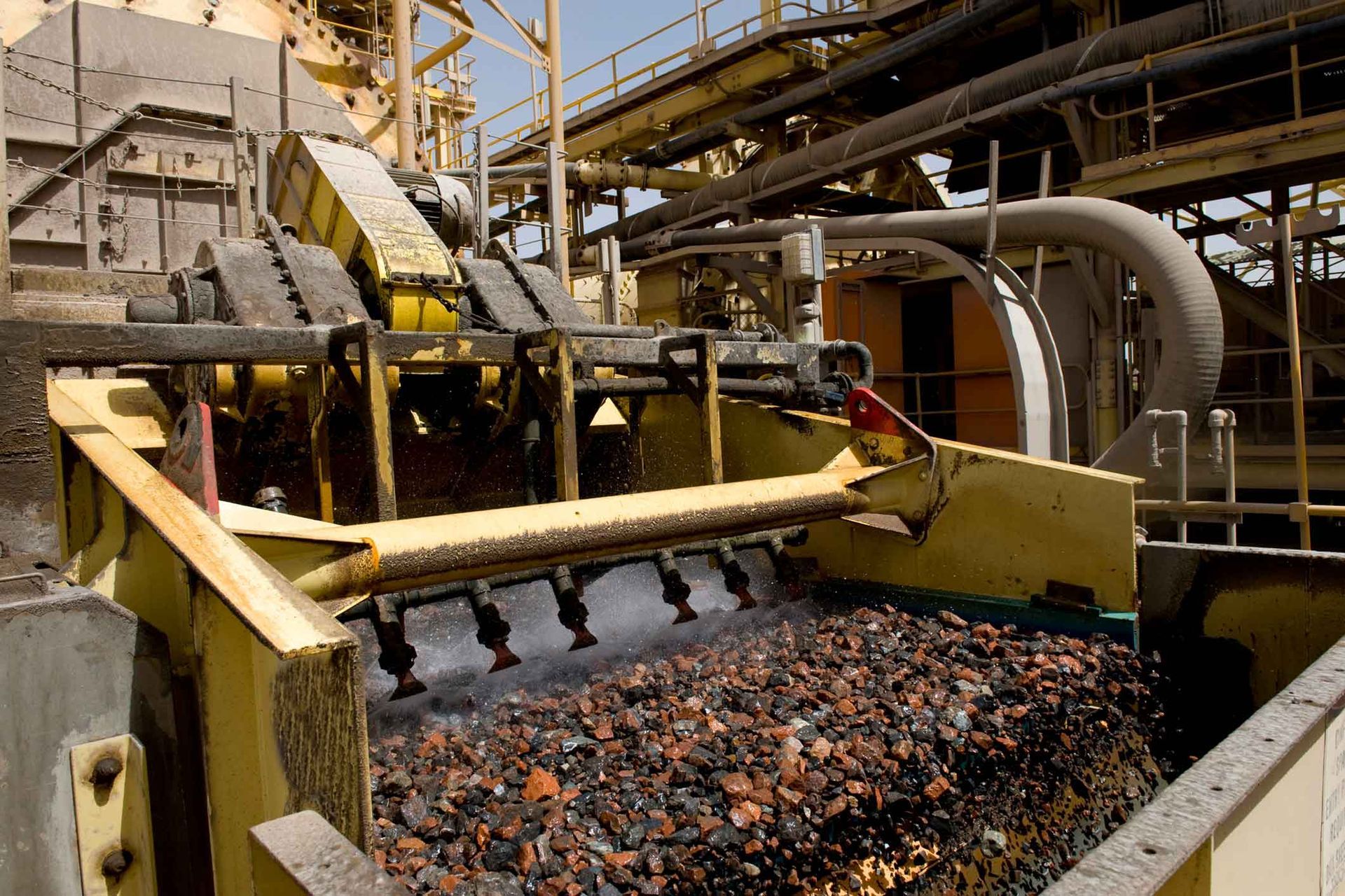 A large pile of rocks is being processed in a factory.