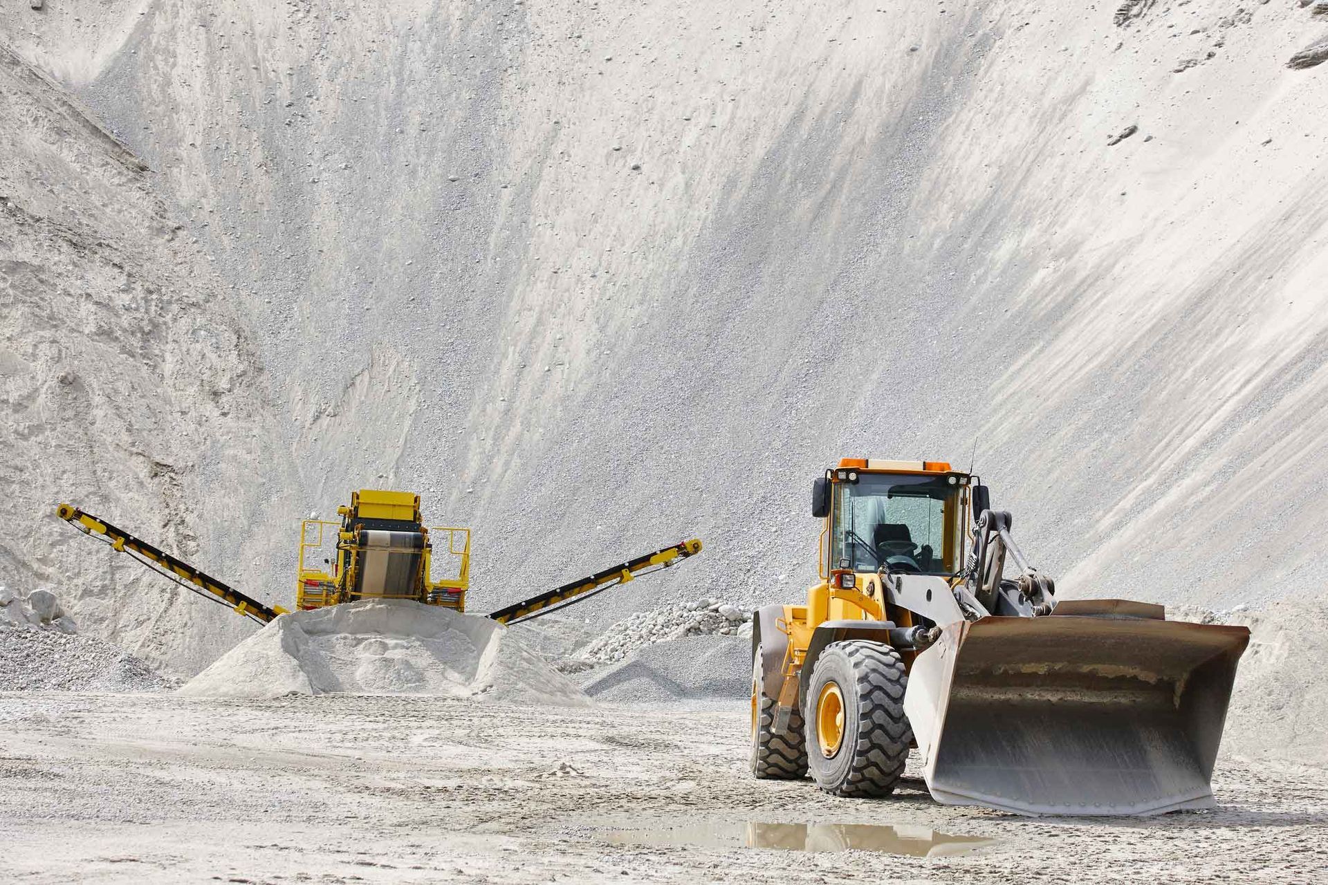 A bulldozer is moving dirt in a quarry.