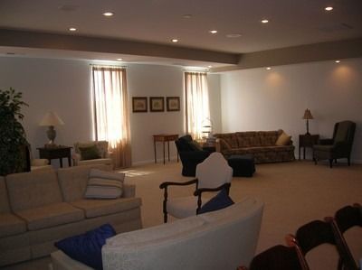 A living room with a couch , chairs and a table