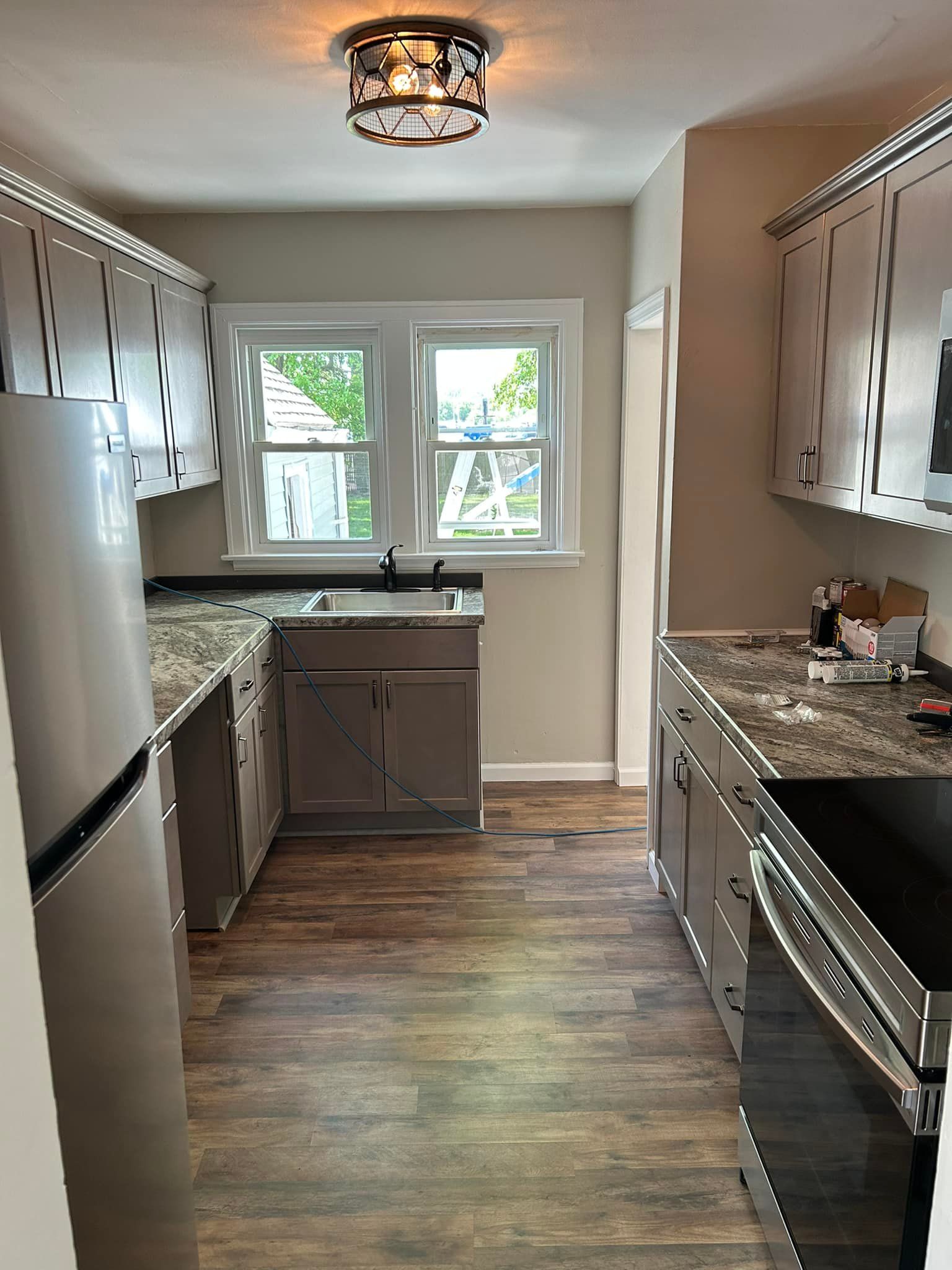 A kitchen with stainless steel appliances and granite counter tops.