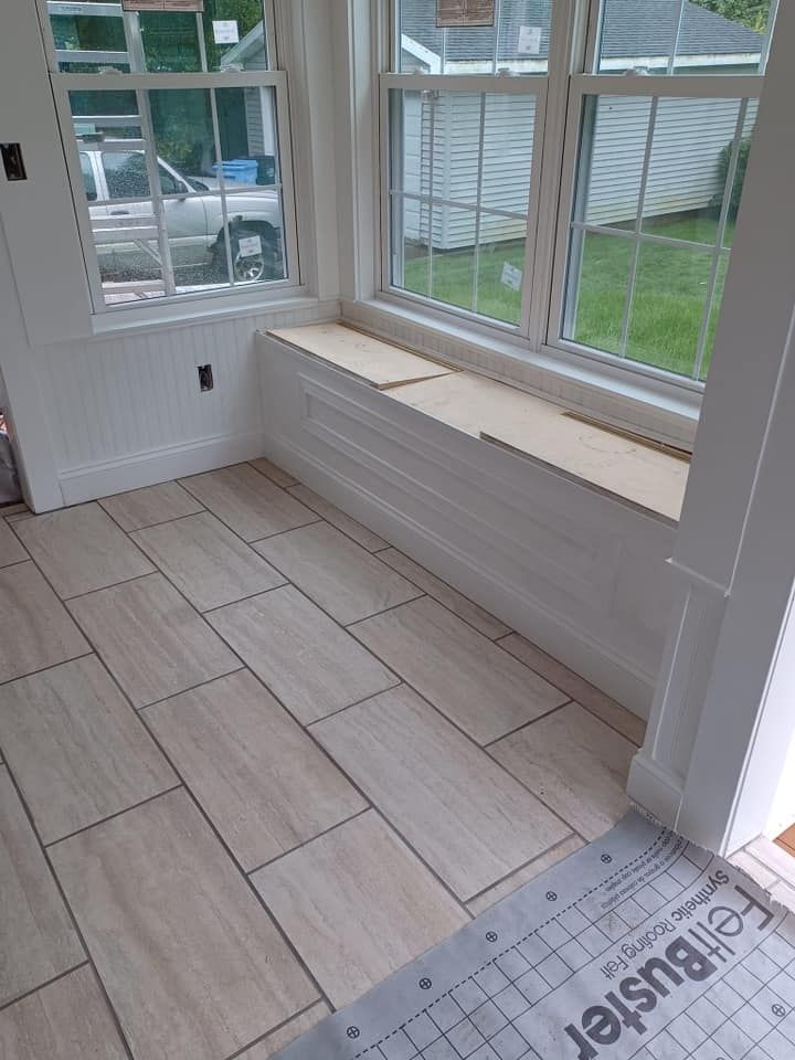 A room with tile floors and a window seat.