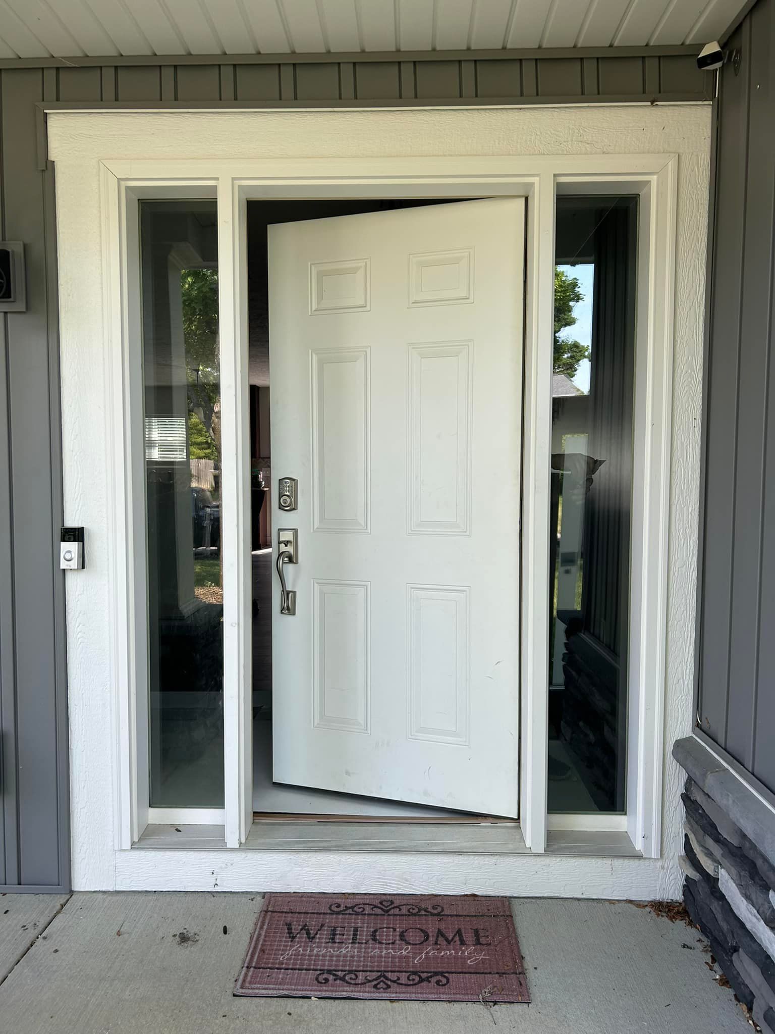 A white door with a welcome mat in front of it