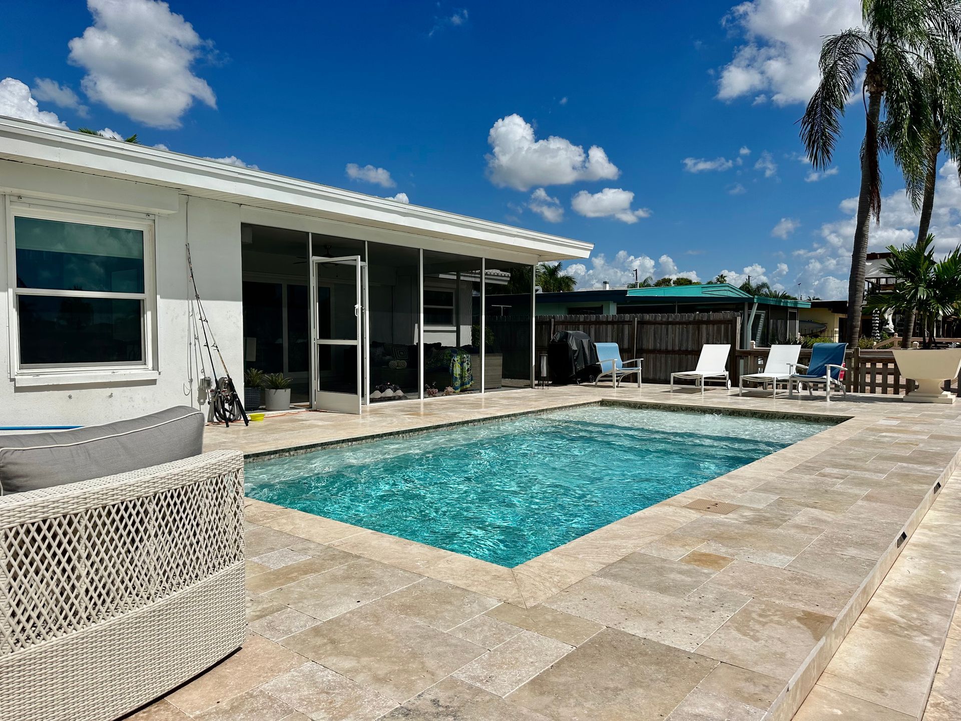 A house with a large swimming pool in front of it
