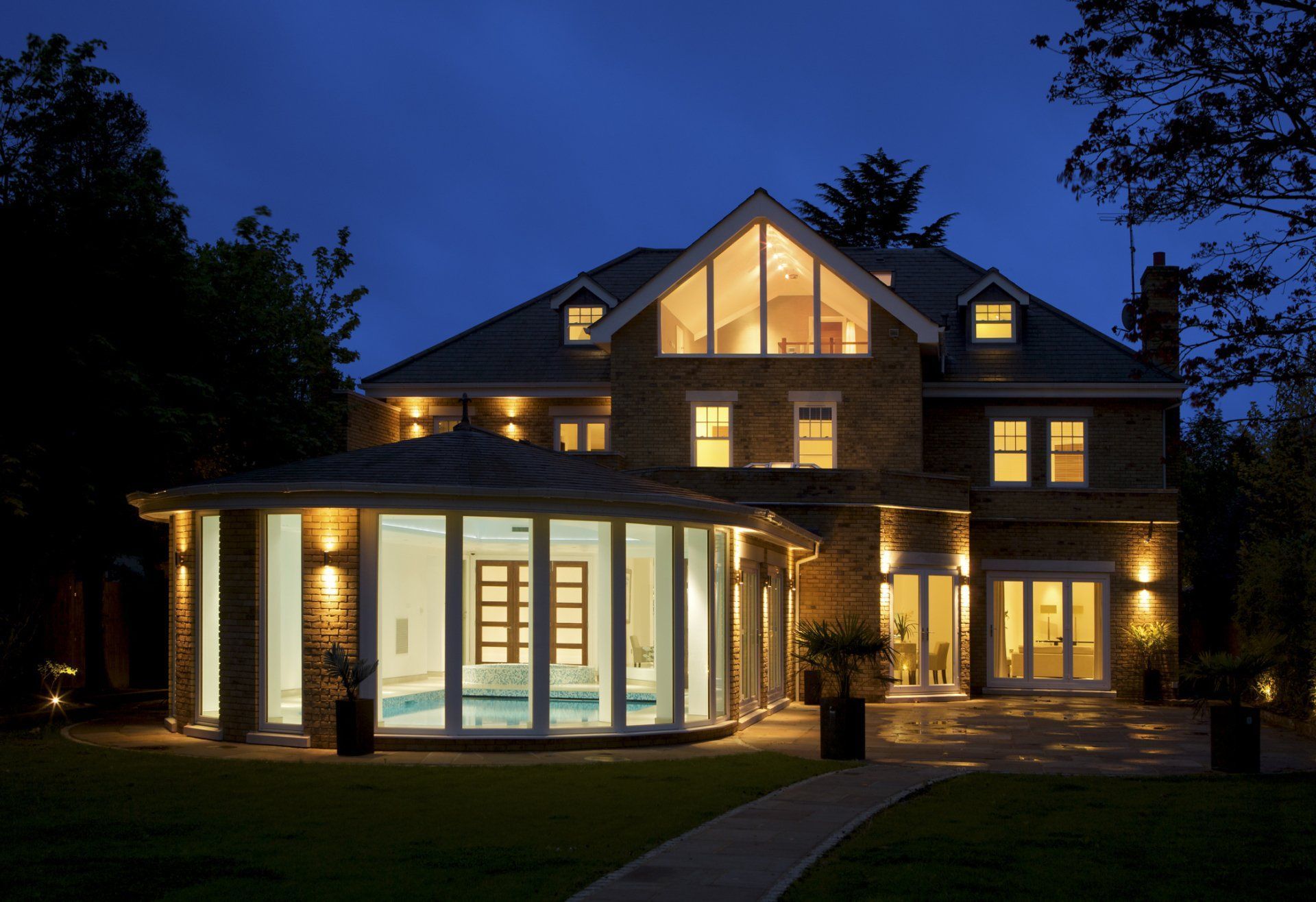 A Large House With A Swimming Pool In The Backyard At Night – Brendale, QLD - DB Electrical