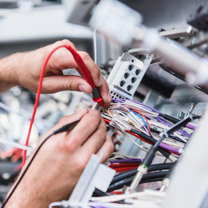 A Man Is Using A Multimeter To Test A Bunch Of Wires – Brendale, QLD - DB Electrical