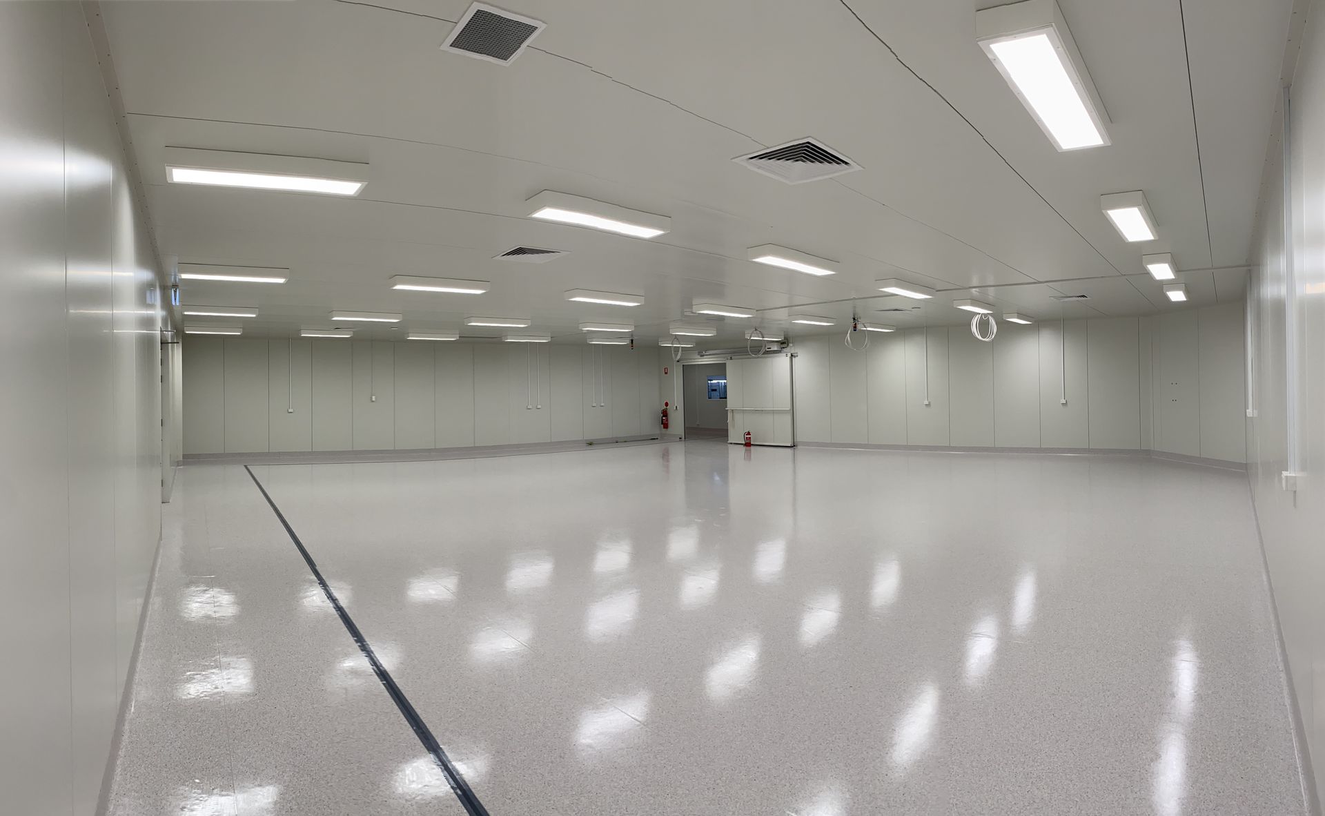 A Large Empty Room With White Walls And A Shiny Floor – Brendale, QLD - DB Electrical