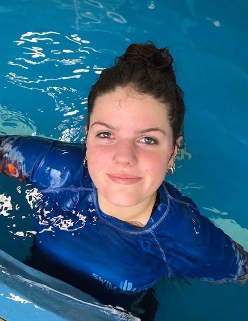 A lady is in a swimming pool while smiling — Swim Care Boambee in Coffs Harbour, NSW