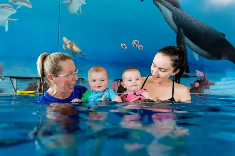 Woman and Baby in Pool, Both Smiling — Swim Care Boambee in Coffs Harbour, NSW