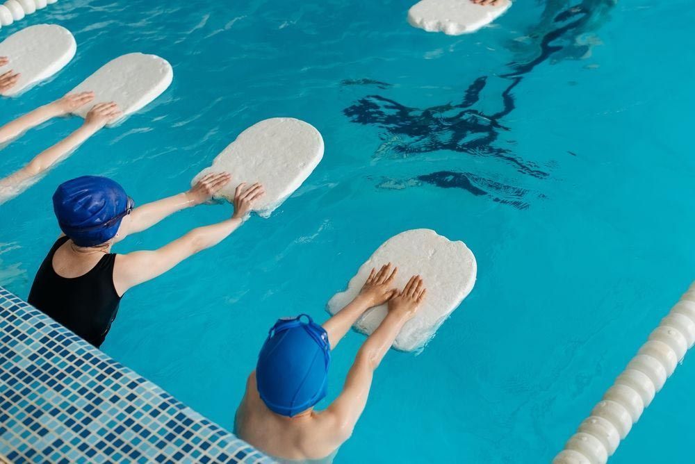 Child in Strawberry Floaty in Pool During Swim Class — Swim Care Boambee in Coffs Harbour, NSW