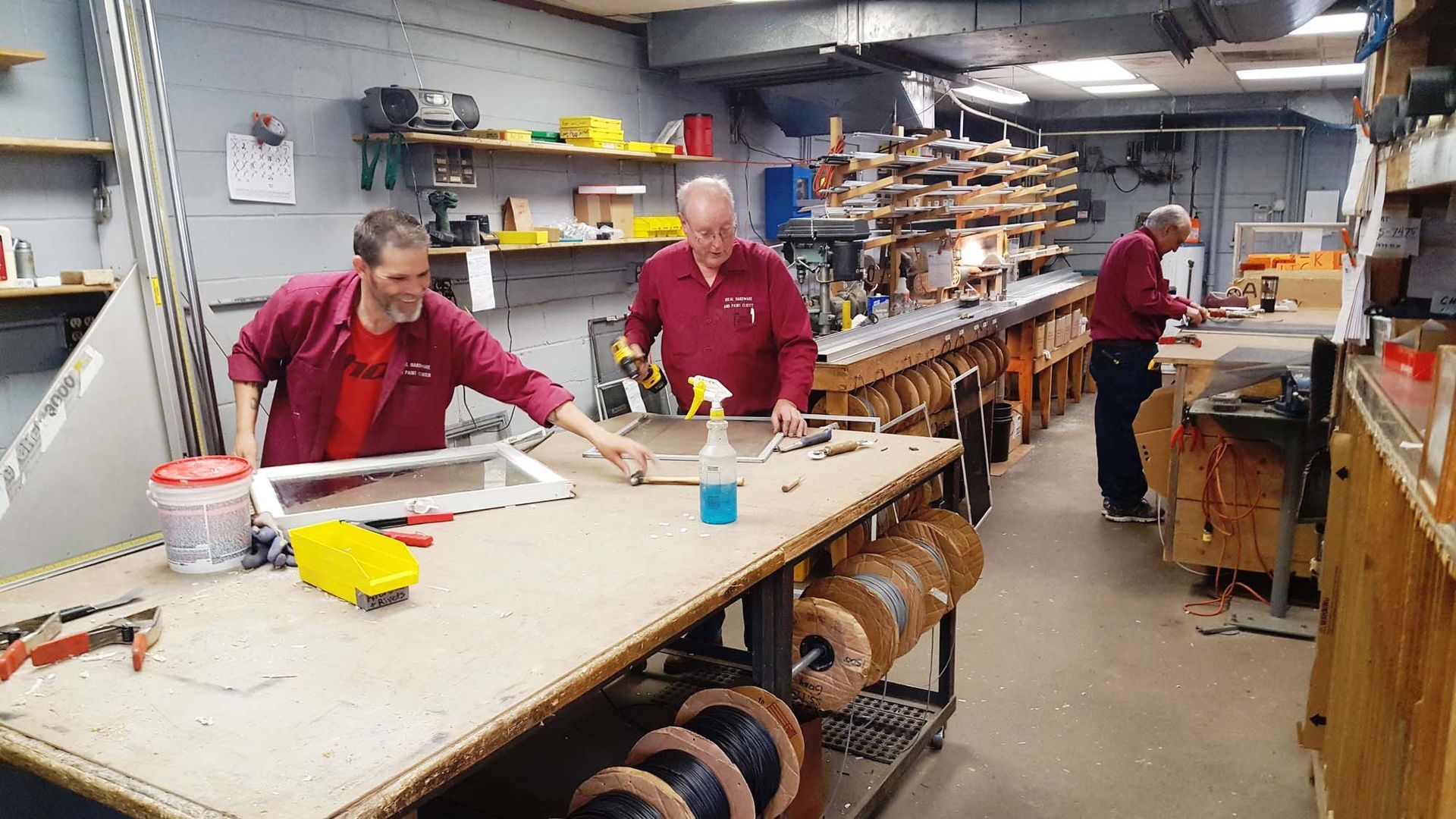 A group of men are working in a workshop.