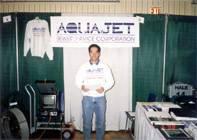 a man is standing in front of a sign that says aquajet .