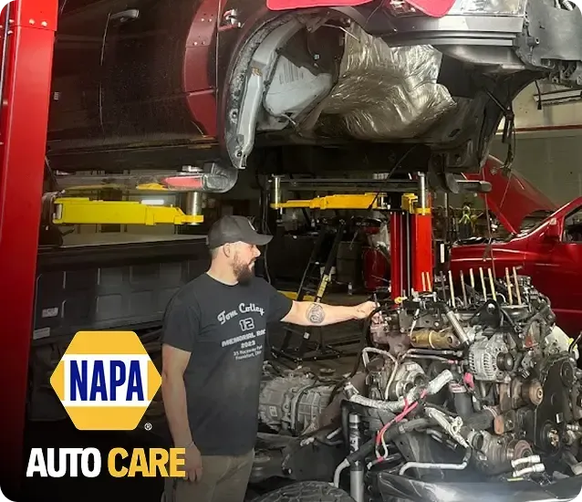Mechanic working in garage with NAPA Auto Care Logo | High Rize Diesel