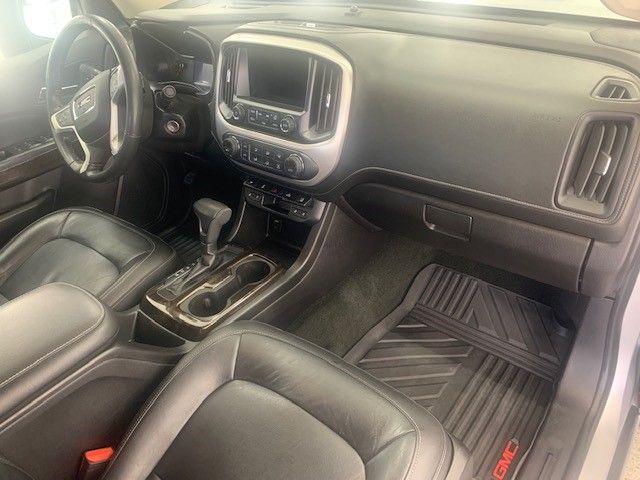 The interior of a white gmc colorado is shown.