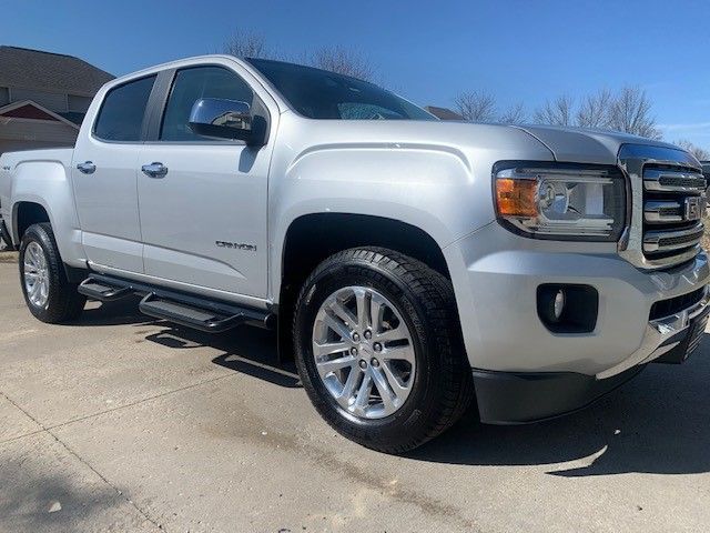 A silver pickup truck is parked in a parking lot.