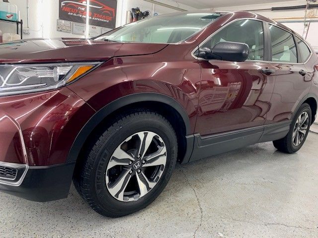 A red honda cr v is parked in a garage.