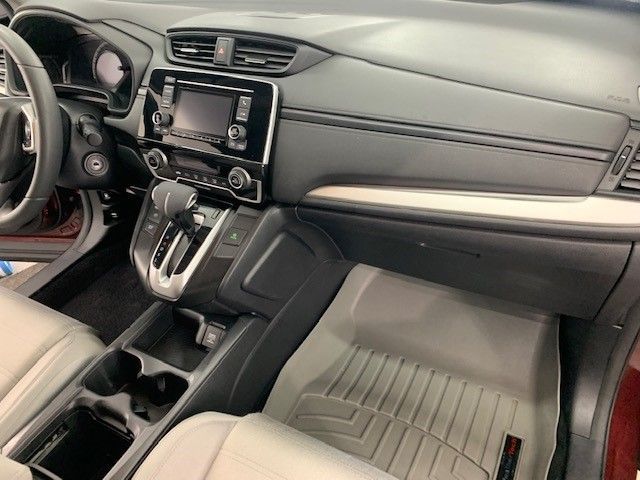 The interior of a car with a steering wheel and a dashboard.